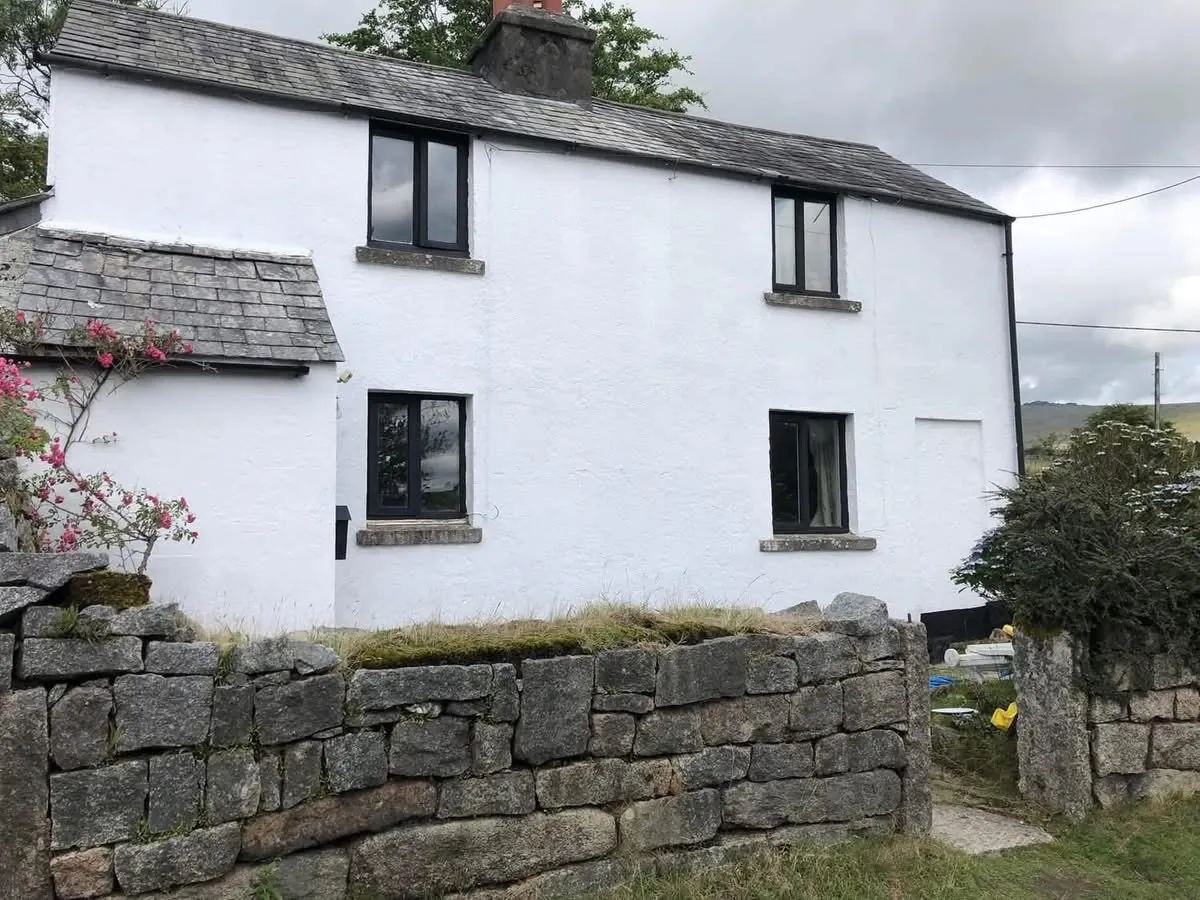 Render repair and exterior repaint of a cottage in Truro